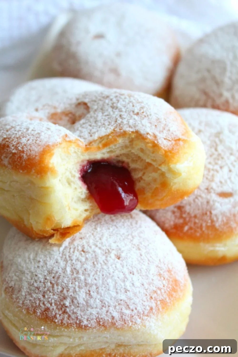 Close up image of jam doughnut with homemade strawberry jam