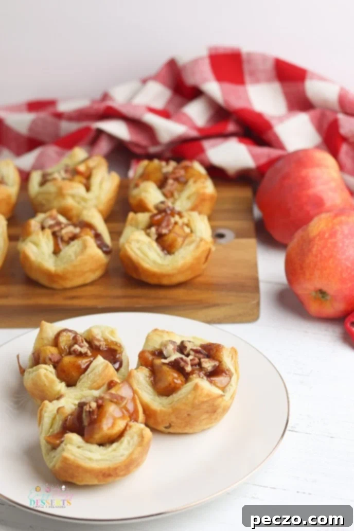 Muffin tin filled with baked mini apple pies