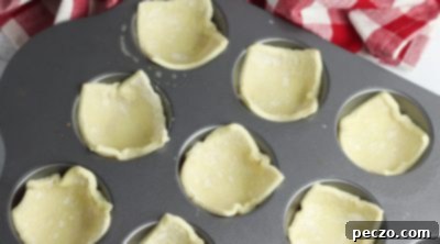 Puff pastry squares pressed into muffin tin cups