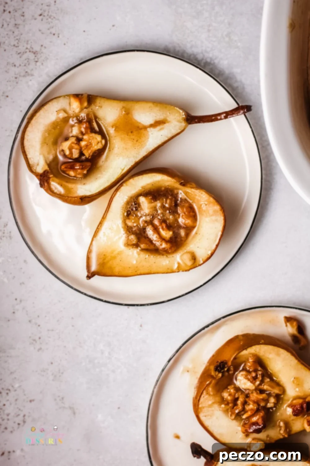 Baked pears with honey in a dessert plate, close-up with a fork.
