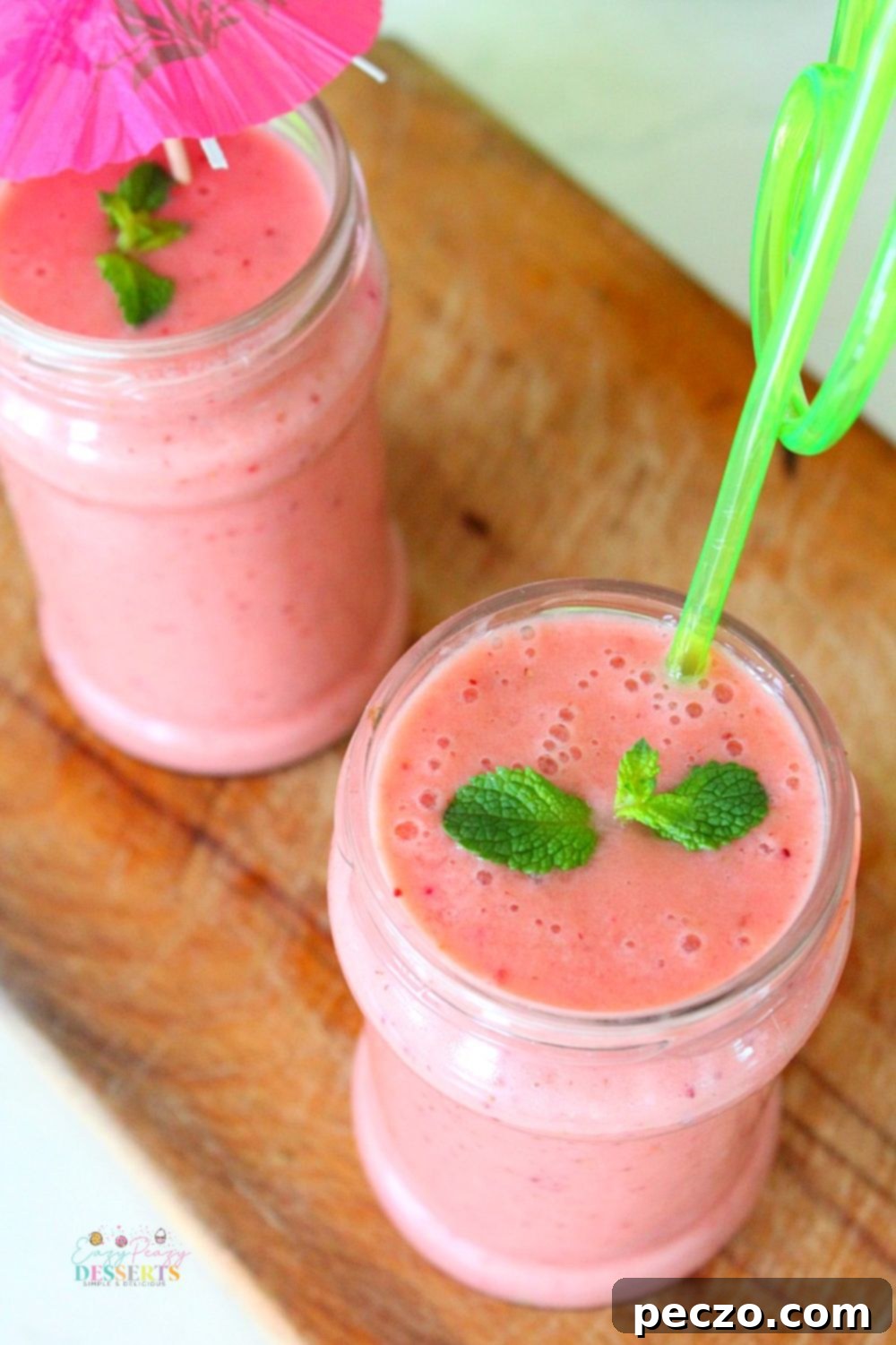 Angled image of jars filled with strawberry protein fruit smoothie