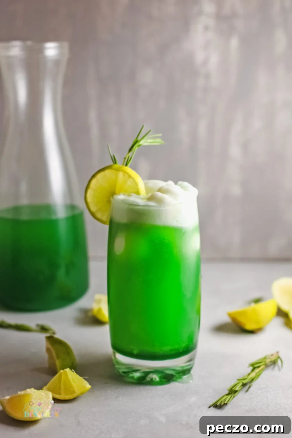 Close-up shot of a glass of refreshing lime sherbet punch, showing the layers of green syrup, sherbet, and soda.