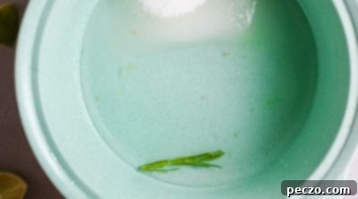 Mixing ingredients for lime simple syrup in a saucepan.