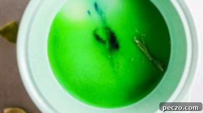Lime simple syrup simmering in a saucepan.