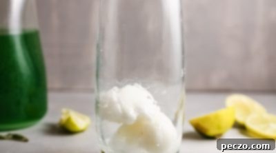 Cooled lime simple syrup in a glass jar.