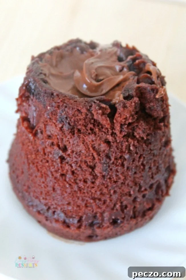 Angle image of Nutella lava cake in a mug, showing the molten center