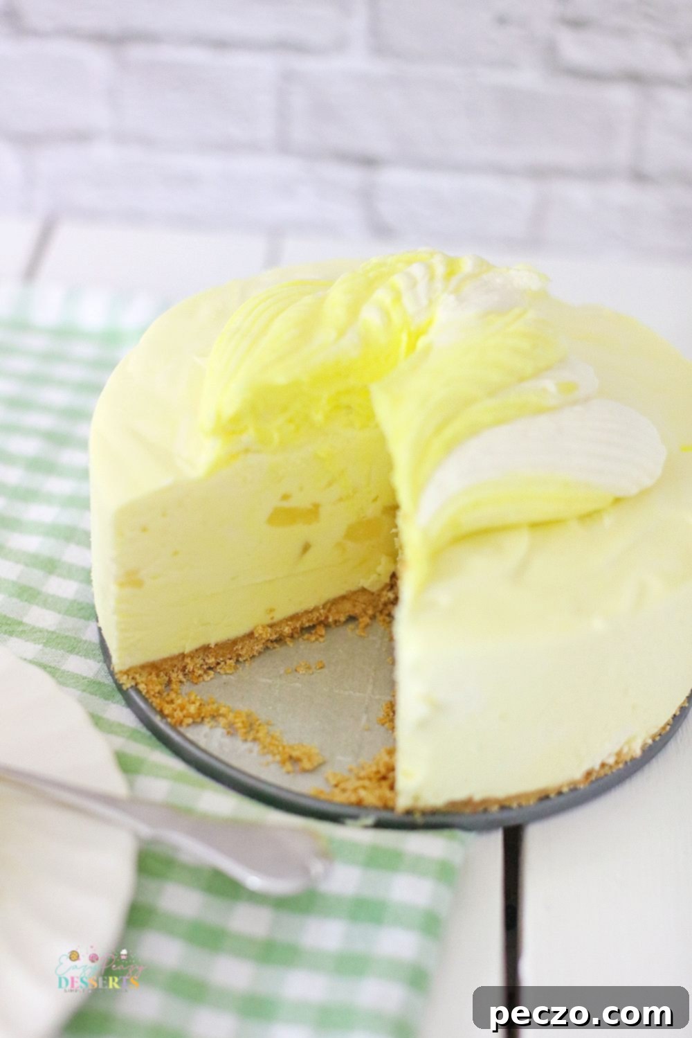 Easy no-bake pineapple cheesecake chilling in a springform pan, ready for the freezer.