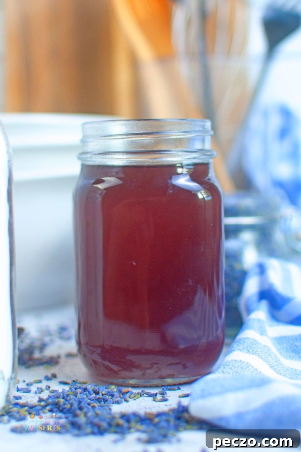 Close up image of a glass jar filled with lavender syrup