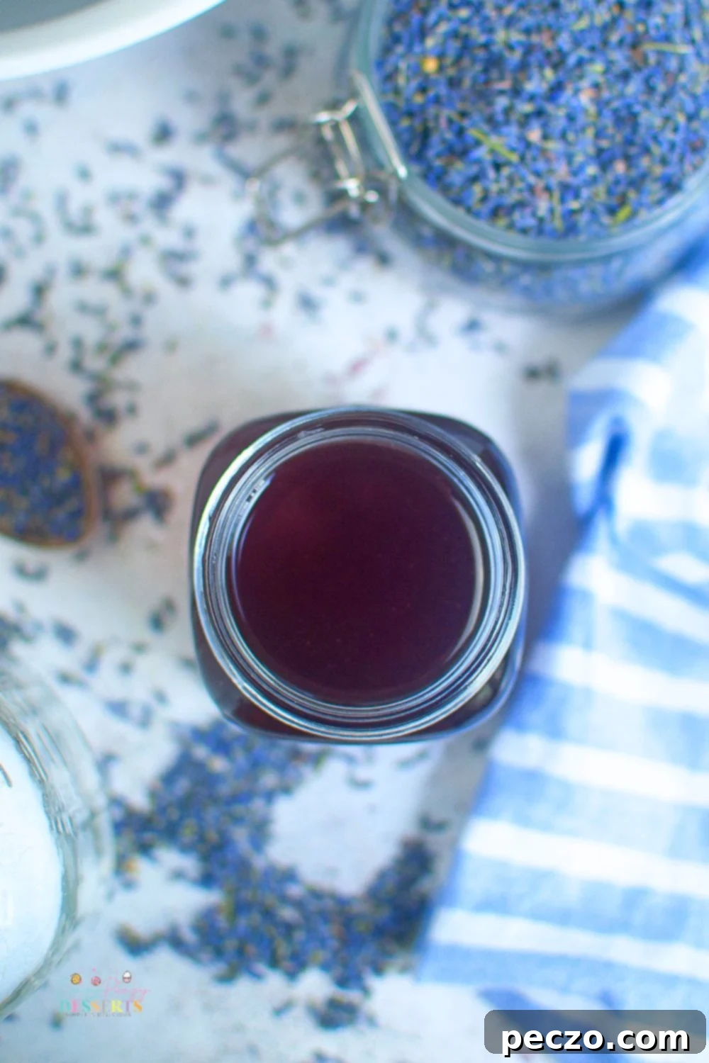 Over head image of a glass jar filled with homemade lavender syrup
