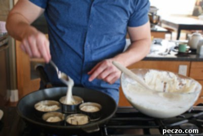Pierre's Signature Crumpets 3 Close-up of Pierre tending to crumpets cooking in rings on a griddle