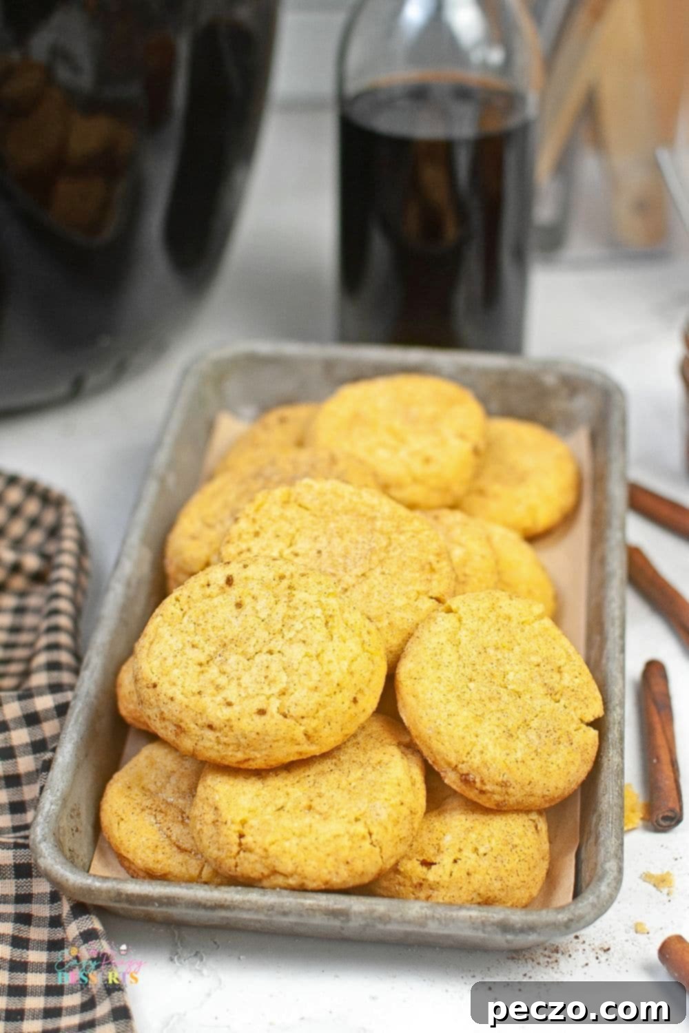 Pumpkin snickerdoodle cookies on a cookie sheet