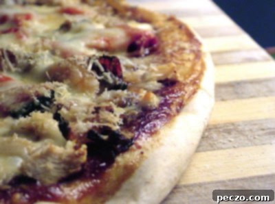 Homemade BBQ Turkey Pizza with caramelized onions and roasted red pepper