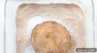 Coating pumpkin pie bombs with cinnamon sugar