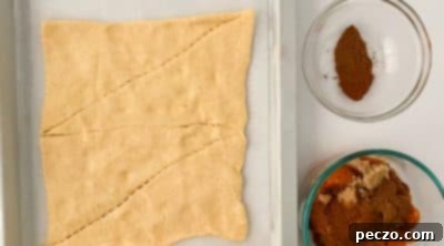Rolling out crescent roll dough and pressing seams together.