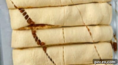 Cutting the layered pumpkin dough into uniform strips.