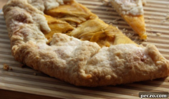 Beautifully arranged mango slices on a rustic galette crust