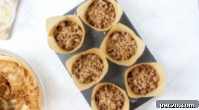 Freshly baked gingerbread streusel muffins in a muffin tin