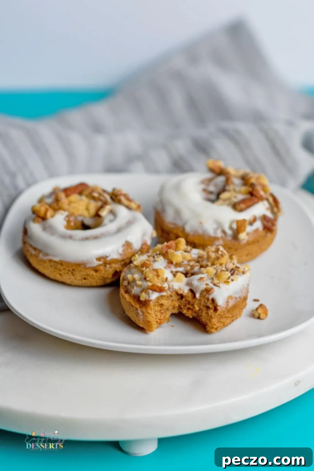 Close up of freshly baked carrot donuts with cream cheese icing.