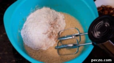Dry ingredients being added to wet ingredients for donut batter.