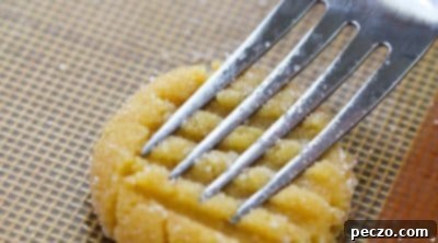 Pressing fork marks on cookie dough