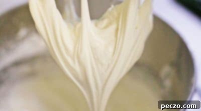 Adding powdered sugar to royal icing mixture