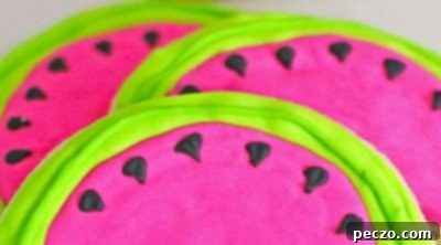 Watermelon slice cookies with set icing on a plate