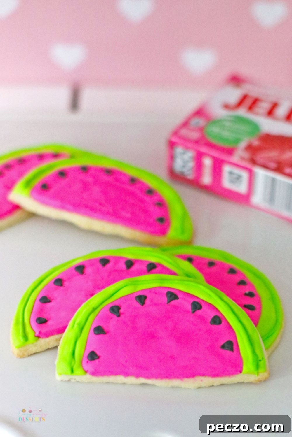 Decorating watermelon cookies with colorful icing
