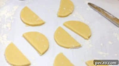 Cutting round cookies and then in half for watermelon slices
