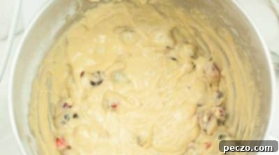 Folding cranberries into muffin batter