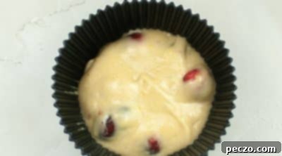 Scooping muffin batter into liners
