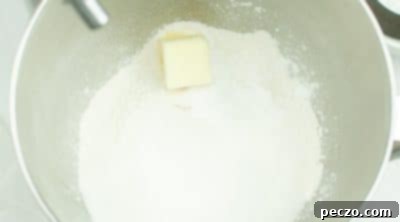 Mixing dry ingredients and butter for muffins