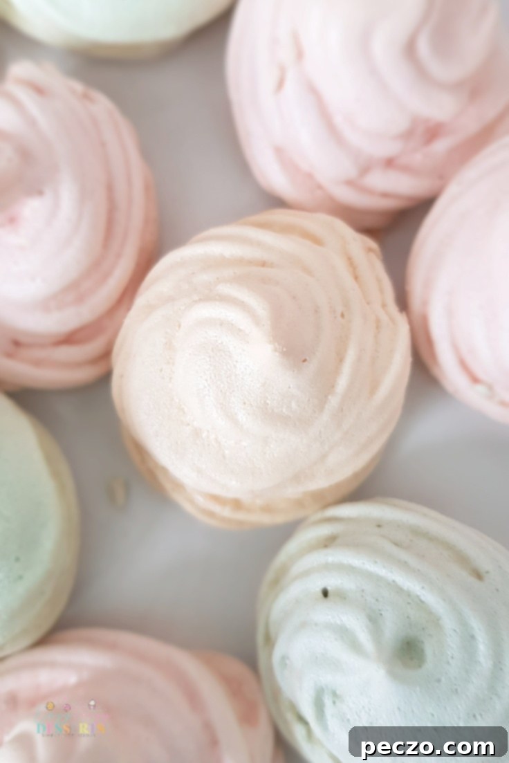 Another appealing shot of mini meringue cookies, emphasizing their light texture and varied colors, perfect for any occasion.