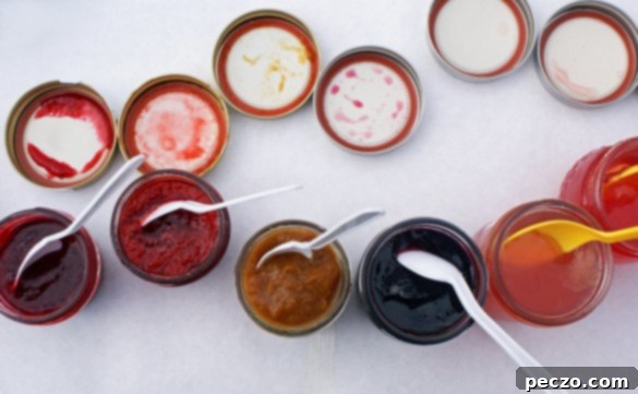A vibrant selection of homemade jams in glass jars, showcasing the colorful bounty of the harvest. These fruit preserves are ready for tasting.