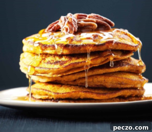 Fluffy Quinoa Pumpkin Pancakes stack drizzled with maple syrup
