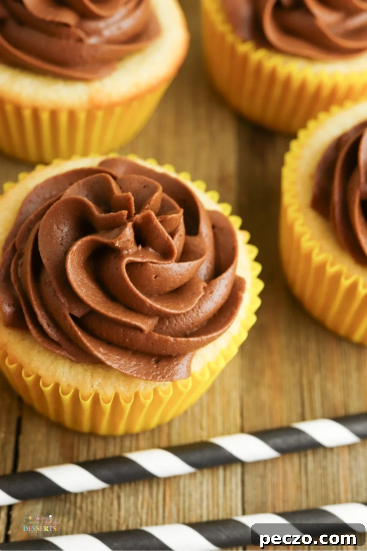Soft, fluffy, and topped with rich chocolate buttercream, these yellow cupcakes are a must-bake treat for any occasion!