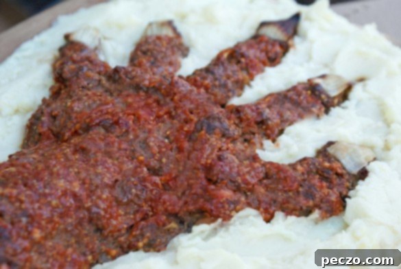 Realistic meatloaf shaped like a severed hand, served on a plate.