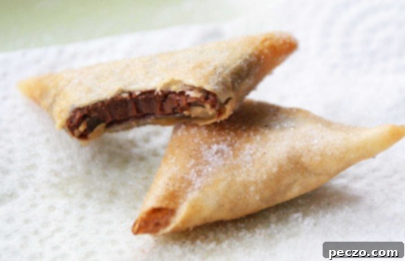 Delicious Nutella Samosas, crispy and golden-brown, served on a plate with chocolate drizzle