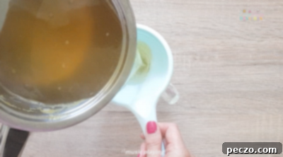 Straining peach syrup through a fine sieve