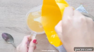 Mixing peach syrup, water, and lemon juice in a pitcher