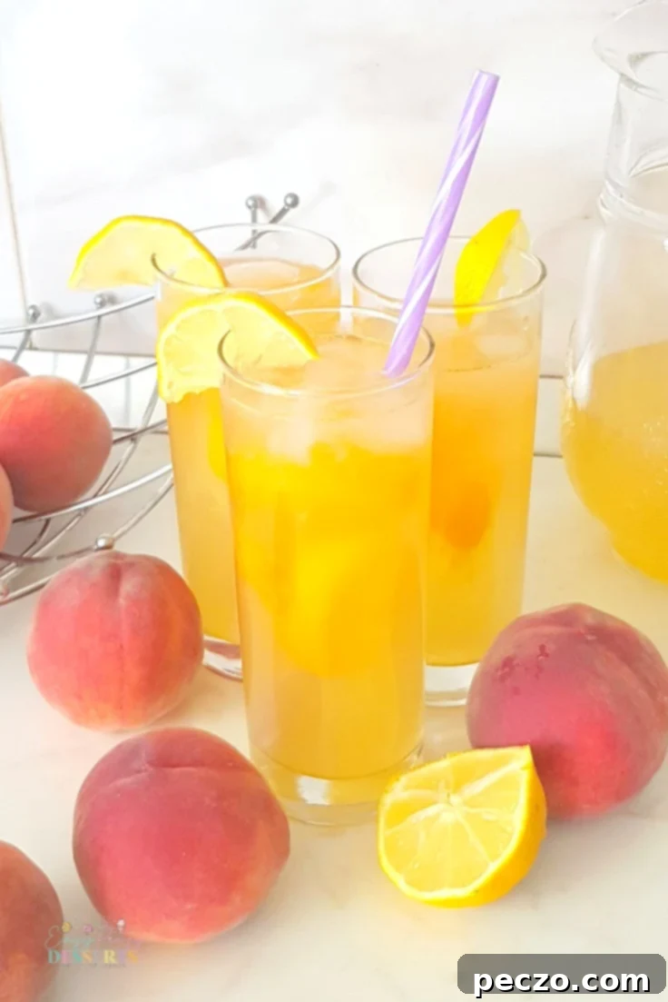 Pitcher of homemade peach lemonade with glasses