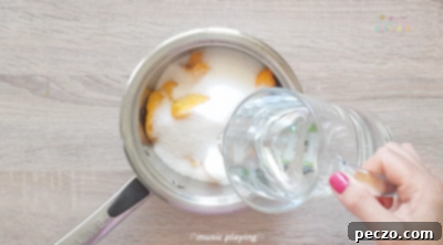 Simmering peaches, sugar, and water in a saucepan