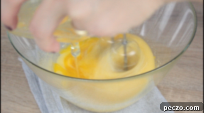 Adding eggs to cake batter